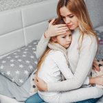 Mother with her illnes daughter in a bedroom